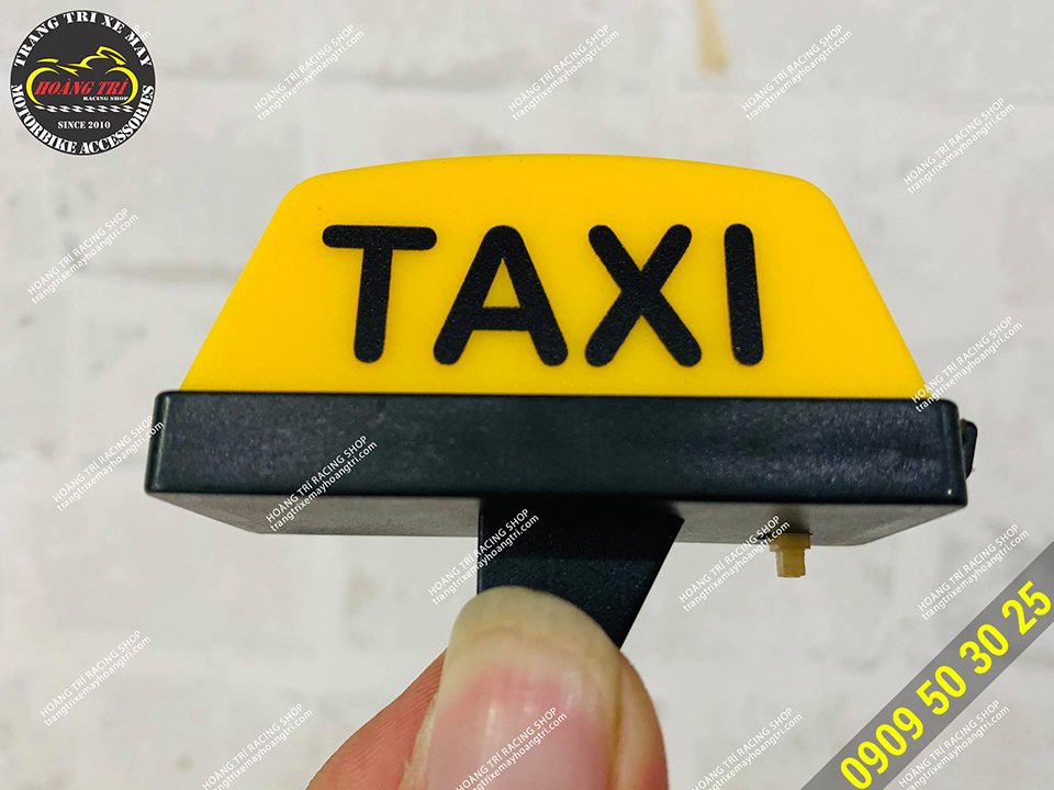 Yellow compact taxi light box in hand