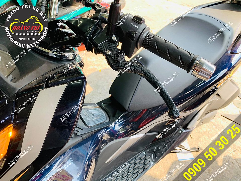 Close-up view of the PCX carbon diamond handbrake installed on the car (left hand brake)