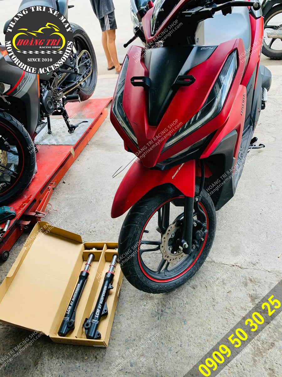 A pair of white LCM forks are preparing to be installed on the car