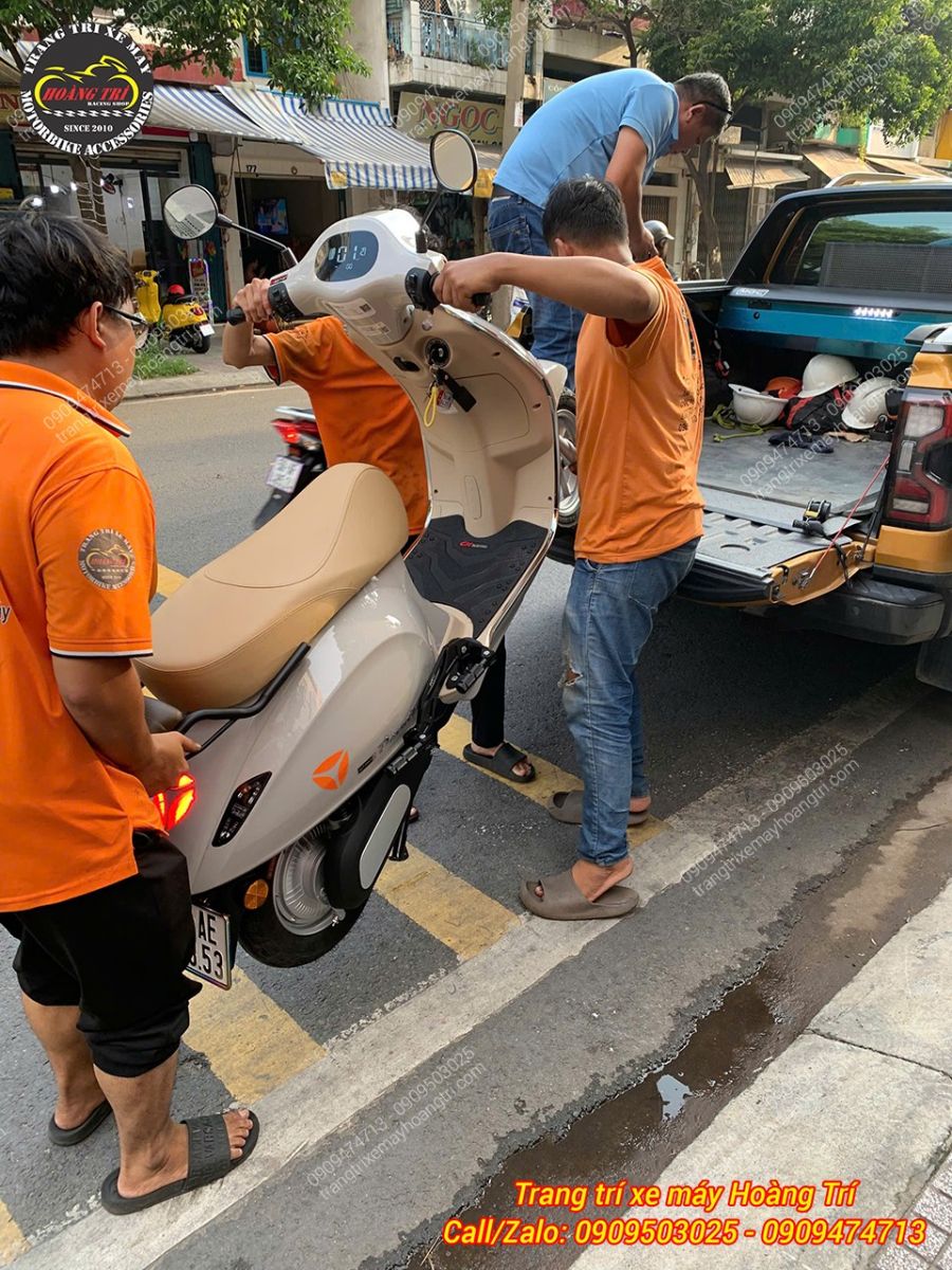 Kỹ thuật viên Hoàng Trí Shop hỗ trợ đưa Yadea Devotion đã hoàn thiện lên xe bàn giao khách