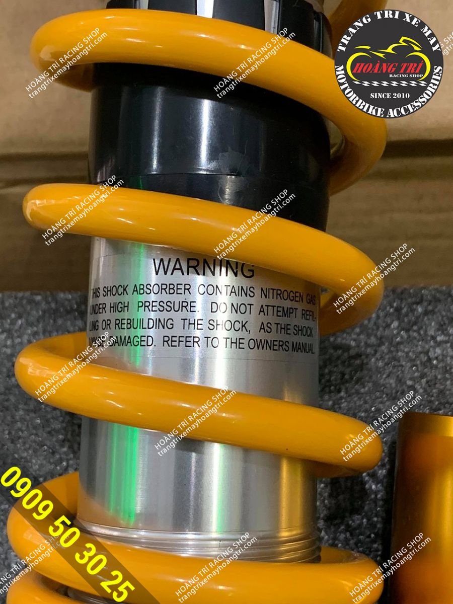 Close-up angle of prominent yellow springs of Ohlins 1:1" fork