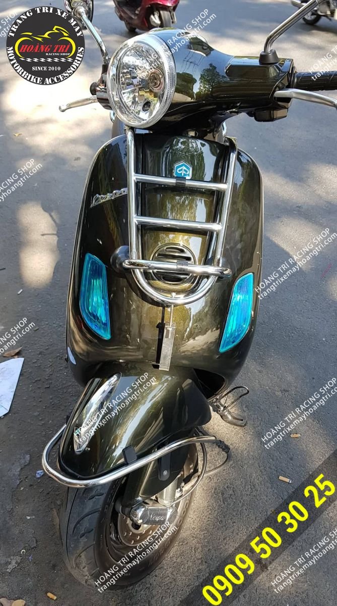 Wearing a stainless steel baga in front of the street with a Vespa LX